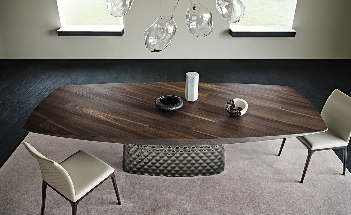 4347d8d4-70d5-4b9f-90c1-75132c16a5db Cattelan Italia's Atrium Masterwood dining table burned oak wooden carved top and metal quilted base top view in an empty dining room.
