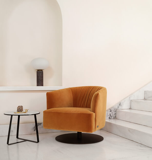 diga-swivel2 orange snug looking circular swivel arm chair on round black base in a sleek hallway
